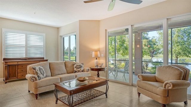 living room featuring ceiling fan, light tile patterned floors, and a healthy amount of sunlight