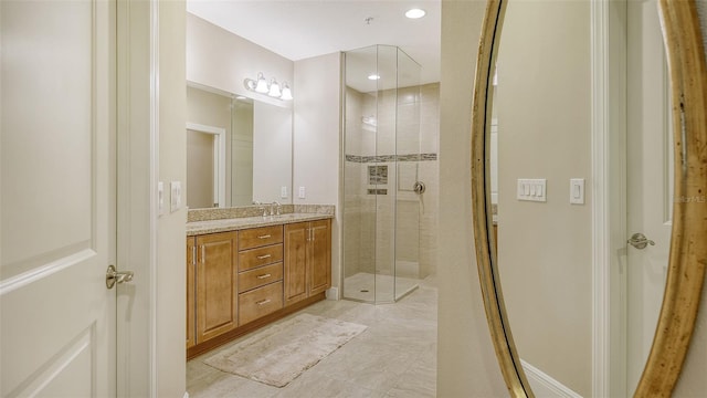 bathroom featuring vanity and an enclosed shower