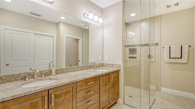 bathroom featuring vanity, tile patterned flooring, and a shower with door