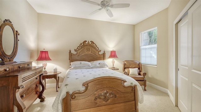 carpeted bedroom featuring ceiling fan and a closet