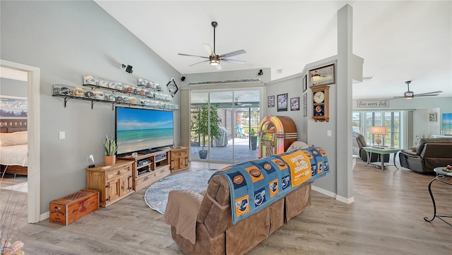 living room with light hardwood / wood-style flooring, ceiling fan, and plenty of natural light