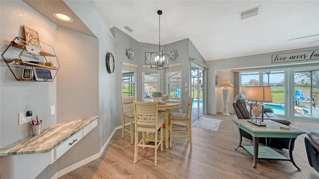 dining room featuring light hardwood / wood-style flooring and an inviting chandelier