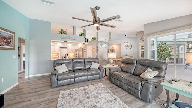 living room with ceiling fan and wood-type flooring