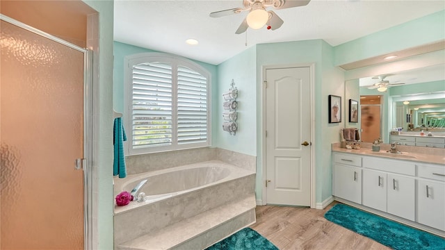 bathroom featuring vanity, hardwood / wood-style floors, independent shower and bath, and ceiling fan