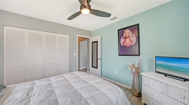 bedroom with a closet, ceiling fan, and light wood-type flooring