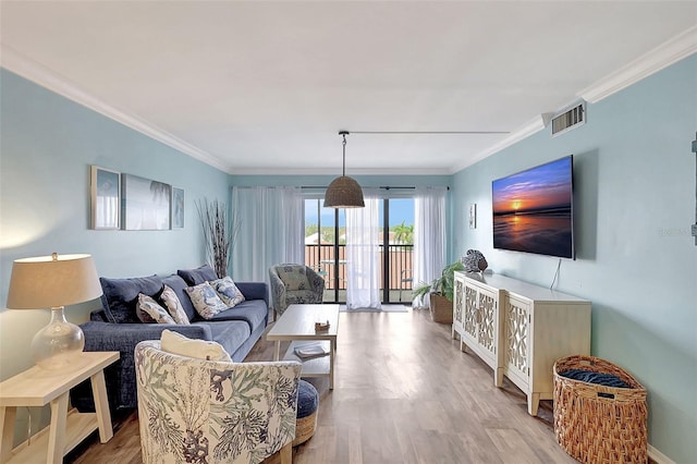 living room with light hardwood / wood-style flooring and ornamental molding