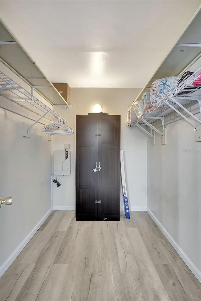 walk in closet featuring light hardwood / wood-style flooring