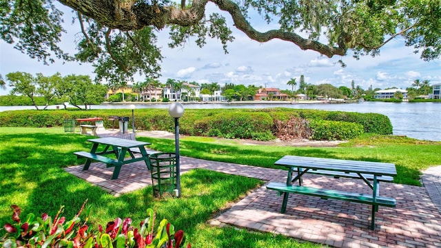 view of property's community featuring a yard and a water view