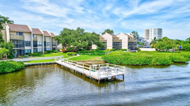 dock area with a water view and a yard