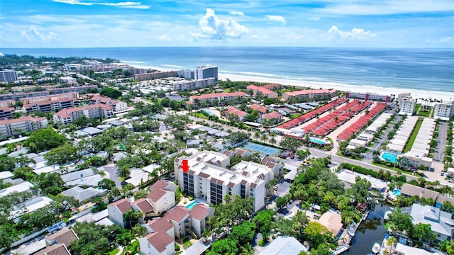 drone / aerial view featuring a water view and a beach view