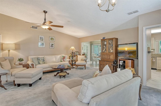 living room with ceiling fan with notable chandelier, vaulted ceiling, and light carpet