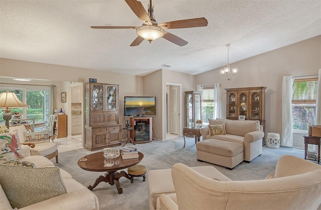 carpeted living room with ceiling fan with notable chandelier, lofted ceiling, and a textured ceiling