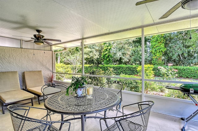 sunroom featuring ceiling fan