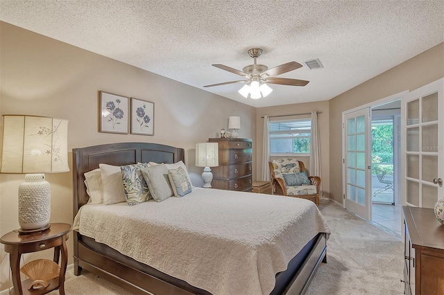 carpeted bedroom with a textured ceiling, ceiling fan, and access to outside