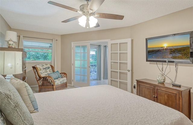 bedroom featuring a textured ceiling, ceiling fan, multiple windows, and french doors