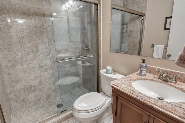 bathroom with vanity, toilet, and walk in shower