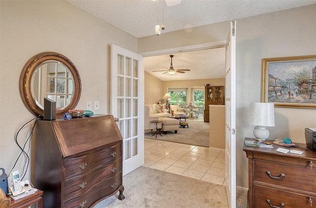 interior space with ceiling fan and a textured ceiling