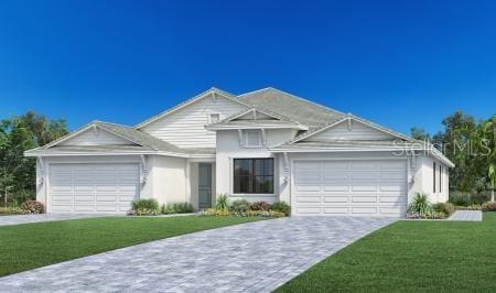 view of front of house with a front yard and a garage