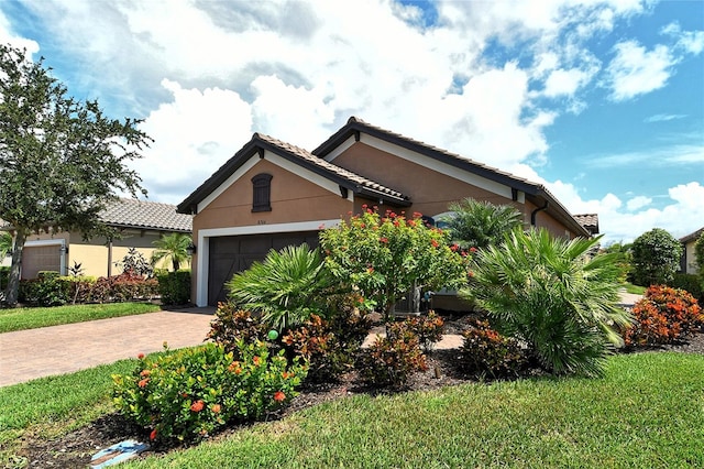 view of front of home with a front yard and a garage