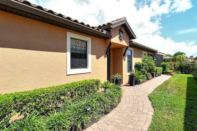 view of side of home featuring a yard