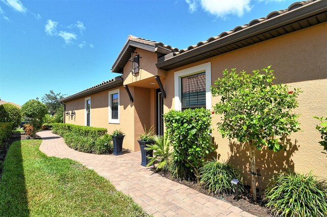 entrance to property with a lawn