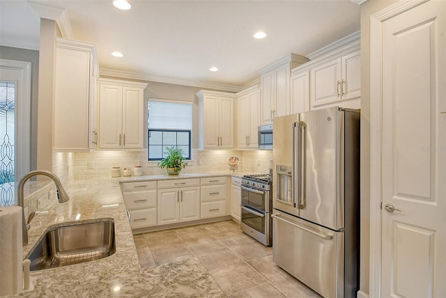 kitchen with sink, ornamental molding, tasteful backsplash, appliances with stainless steel finishes, and light stone countertops