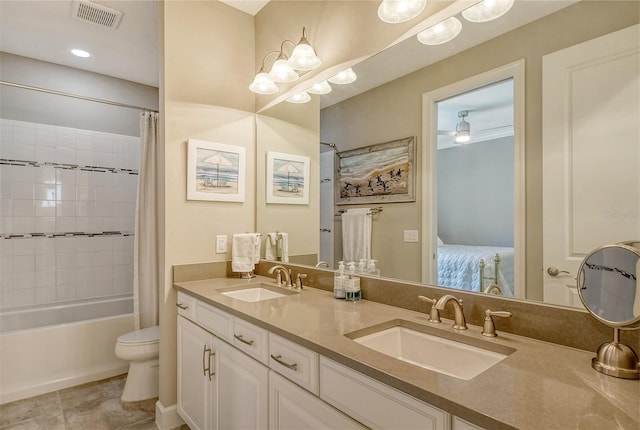 full bathroom with vanity, toilet, shower / bath combo with shower curtain, and tile patterned floors