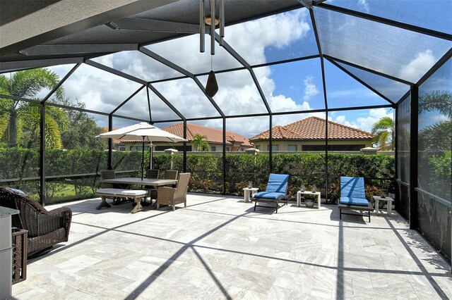 view of patio with glass enclosure