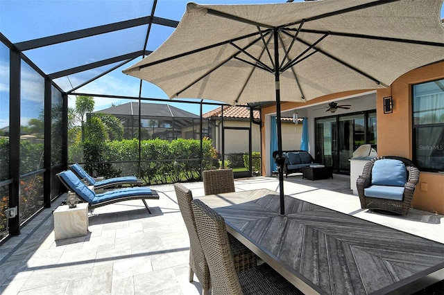 view of patio / terrace with glass enclosure, an outdoor living space, and ceiling fan