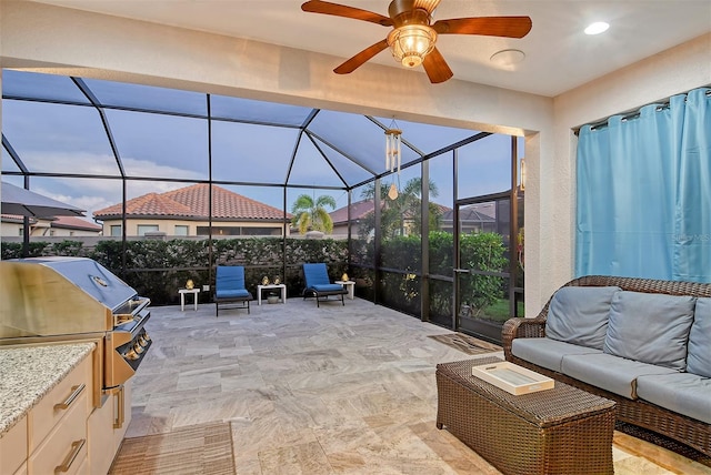 view of patio / terrace featuring ceiling fan, area for grilling, an outdoor living space, an outdoor kitchen, and a lanai