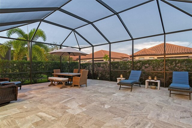 view of patio with glass enclosure