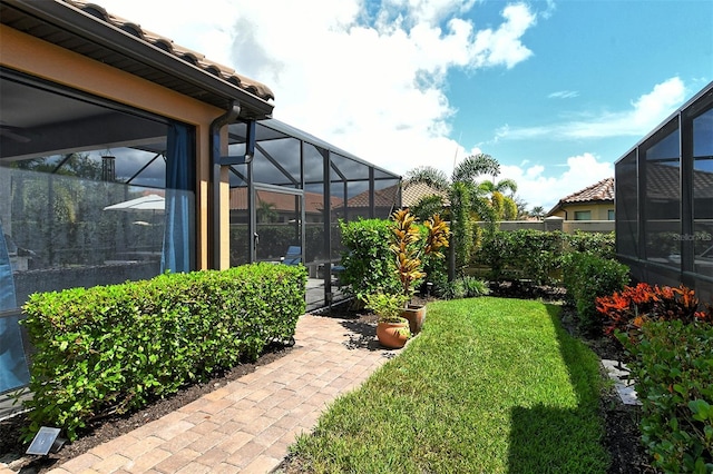 view of yard featuring glass enclosure