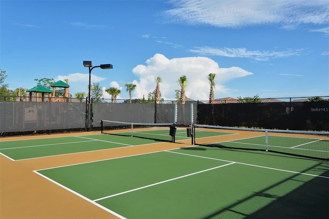 view of tennis court featuring basketball hoop