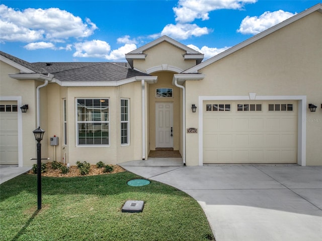 view of front of home featuring a garage and a front lawn