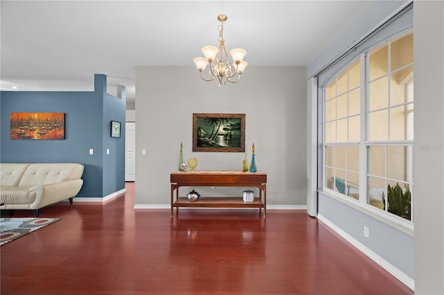 dining area with dark hardwood / wood-style floors and a chandelier