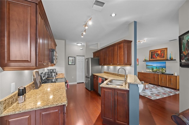 kitchen with dark hardwood / wood-style floors, light stone countertops, sink, and stainless steel appliances