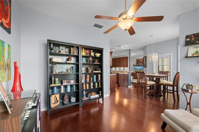 sitting room with ceiling fan with notable chandelier, dark hardwood / wood-style floors, sink, and lofted ceiling