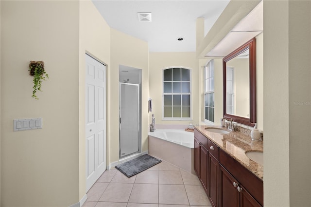 bathroom with independent shower and bath, vanity, and tile patterned flooring