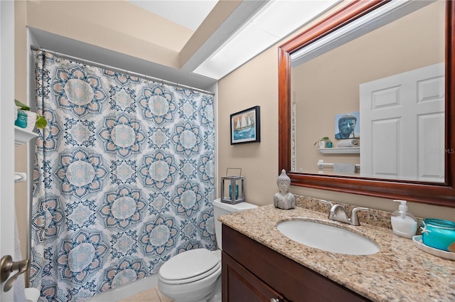 bathroom with tile patterned flooring, curtained shower, vanity, and toilet