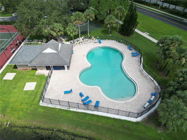 view of swimming pool featuring a patio and a lawn