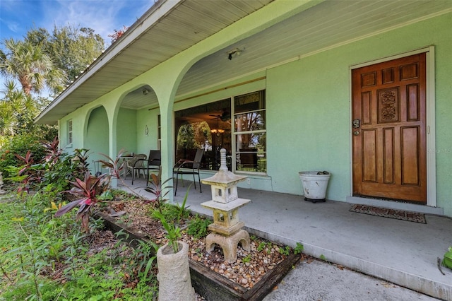 view of exterior entry with a porch