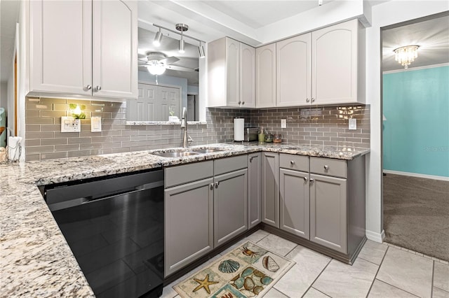 kitchen with decorative backsplash, gray cabinets, ceiling fan, stainless steel dishwasher, and sink