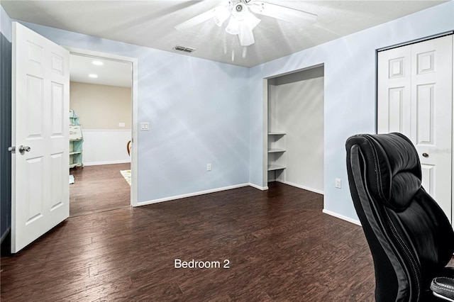 office space featuring ceiling fan and dark wood-type flooring