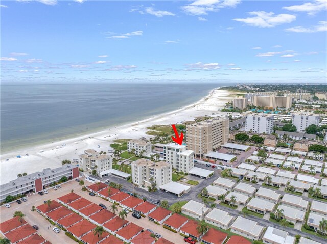 birds eye view of property with a water view and a view of the beach