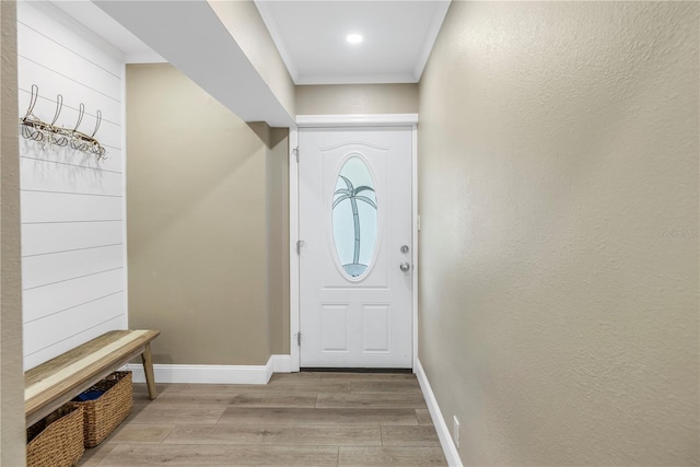 interior space with light hardwood / wood-style floors and ornamental molding