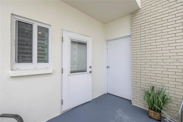 property entrance featuring a patio area