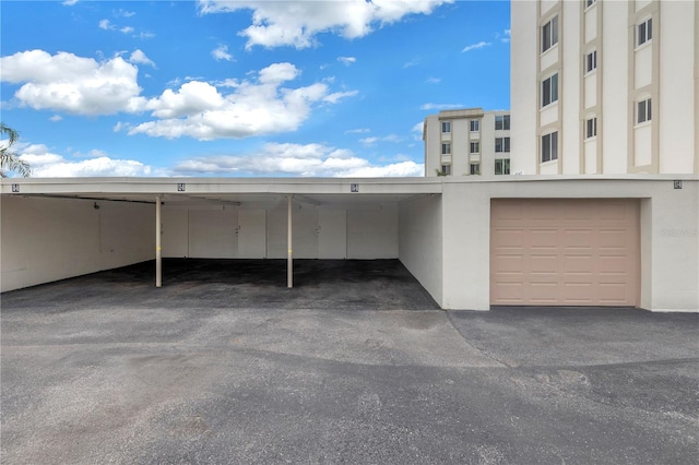 view of car parking with a garage and a carport