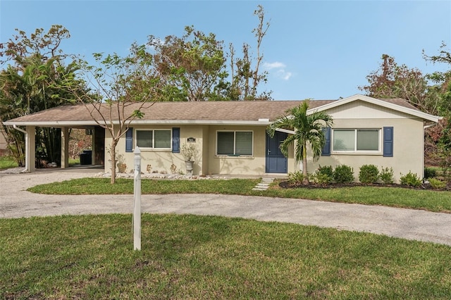 single story home featuring a carport and a front lawn