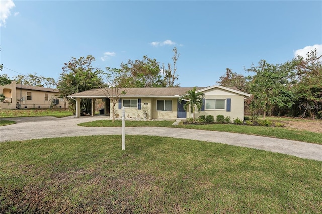 ranch-style home featuring a carport and a front yard