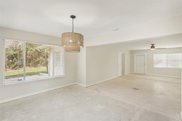 unfurnished room featuring plenty of natural light and ceiling fan